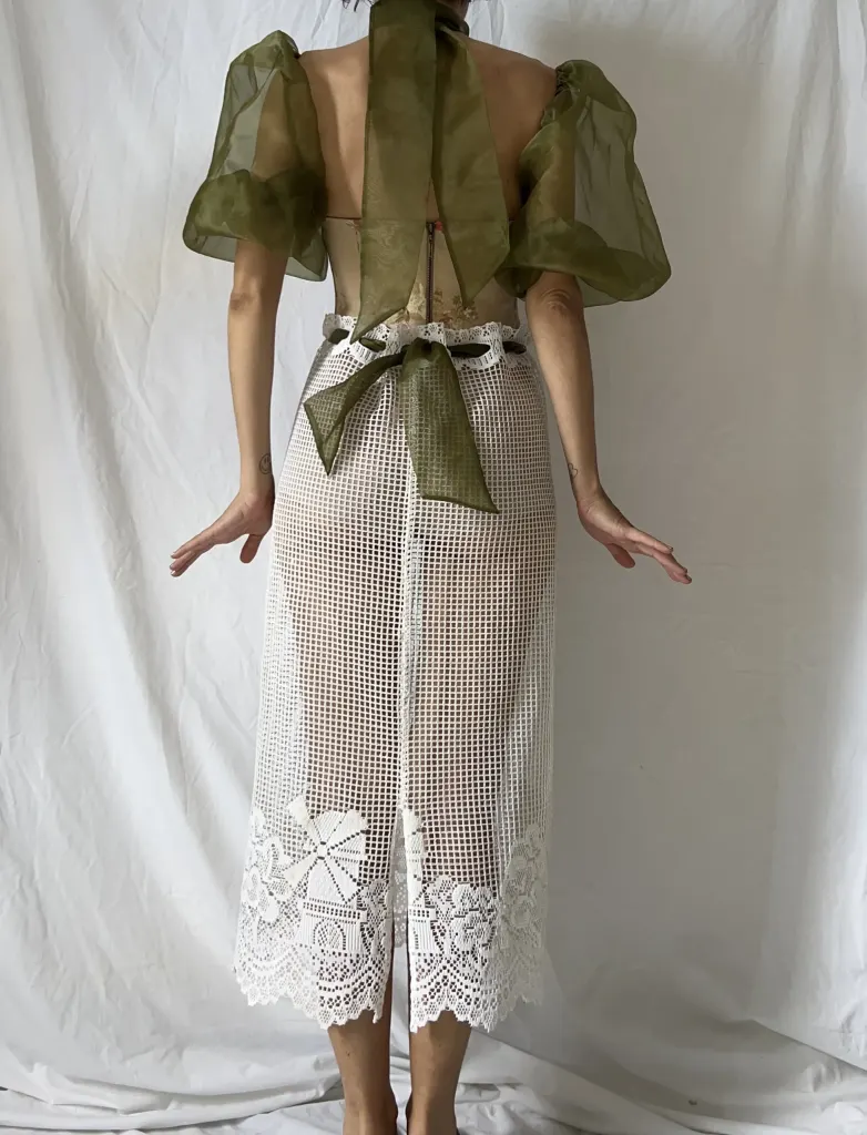 The same look from the back, with the olive organza scarf tied in a bow at the waist.