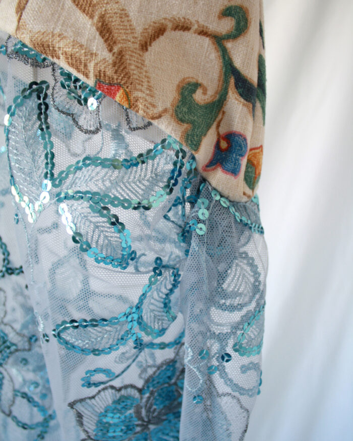 Close up of the the different fabric's textures like sheer sequined fabric, vintage tapestry and taffeta fabric