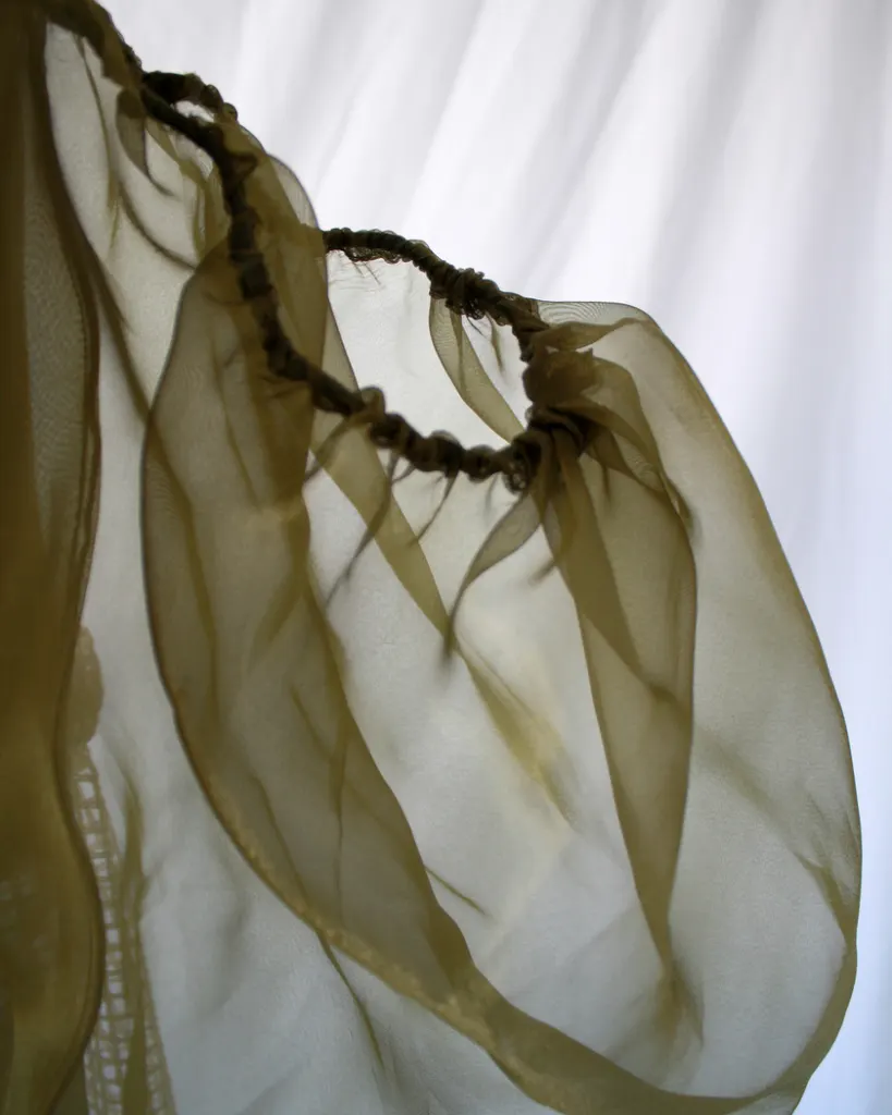 Close up of the sheer bouffant sleeve of this tapestry bustier curtain dress