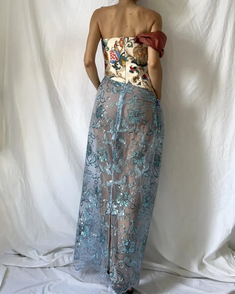 Back close up of this tapestry bustier sequined sheer dress with one sleeve