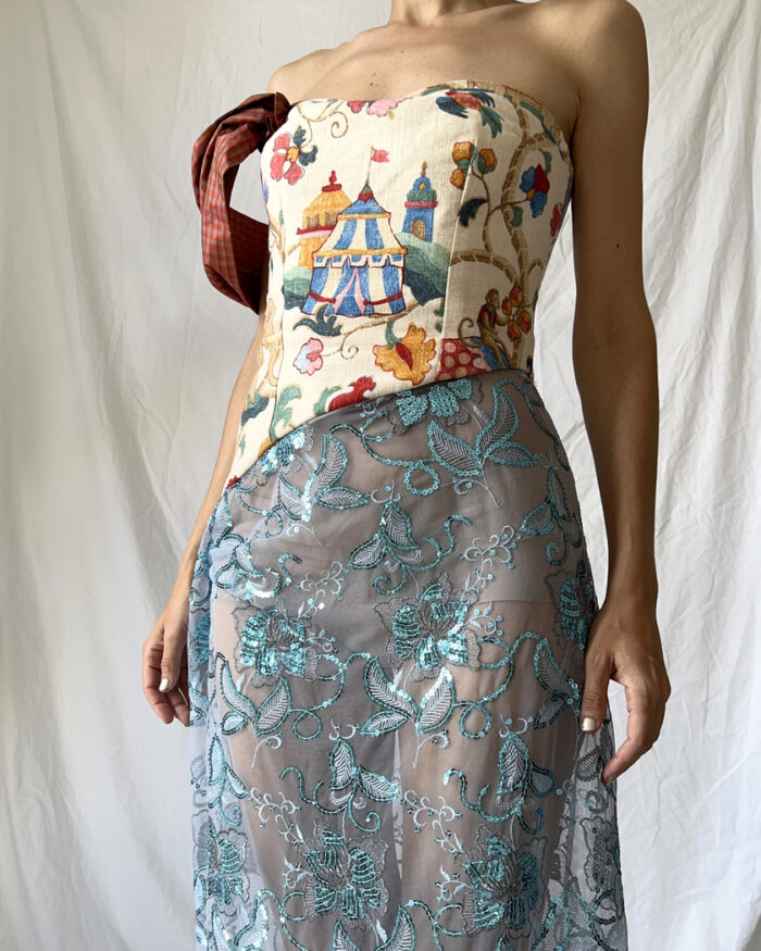 Front close up of this tapestry bustier sequined sheer dress with one sleeve