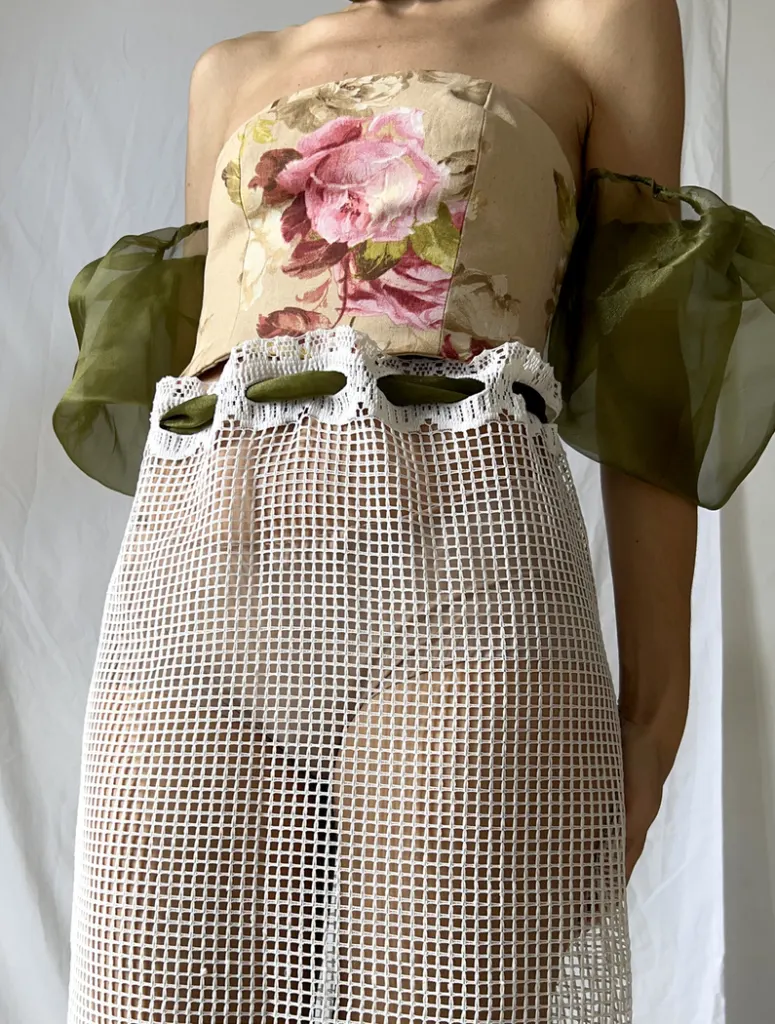 Close up of the front of this vintage bustier tapestry dress with curtain skirt and bouffant sheer sleeves