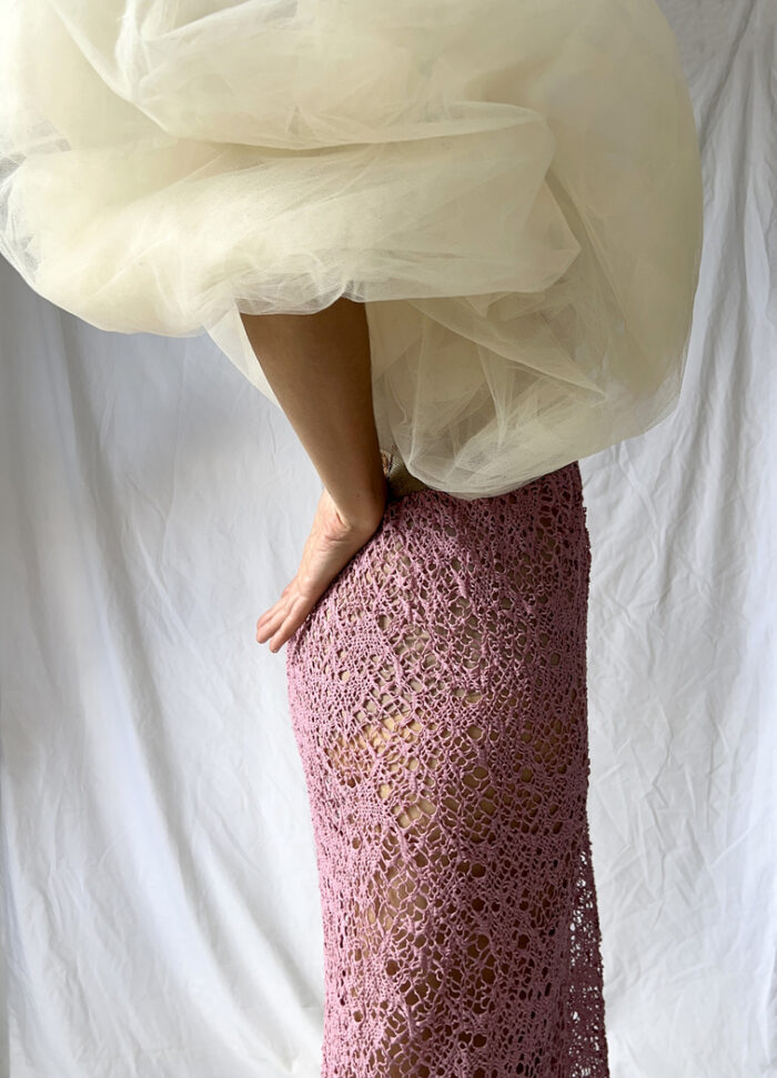 Close up of the cloud tulle sleeve contrasting with the pink open net skirt