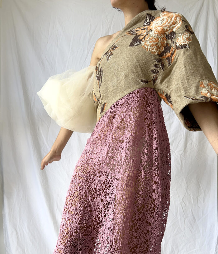 Close up of the front of the tapestry top and pink net skirt of this Japanese style dress with a cloud tulle sleeve