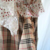 Detail of the combination of two fabrics, plaid check nova fabric and floral embroidered sheer fabric